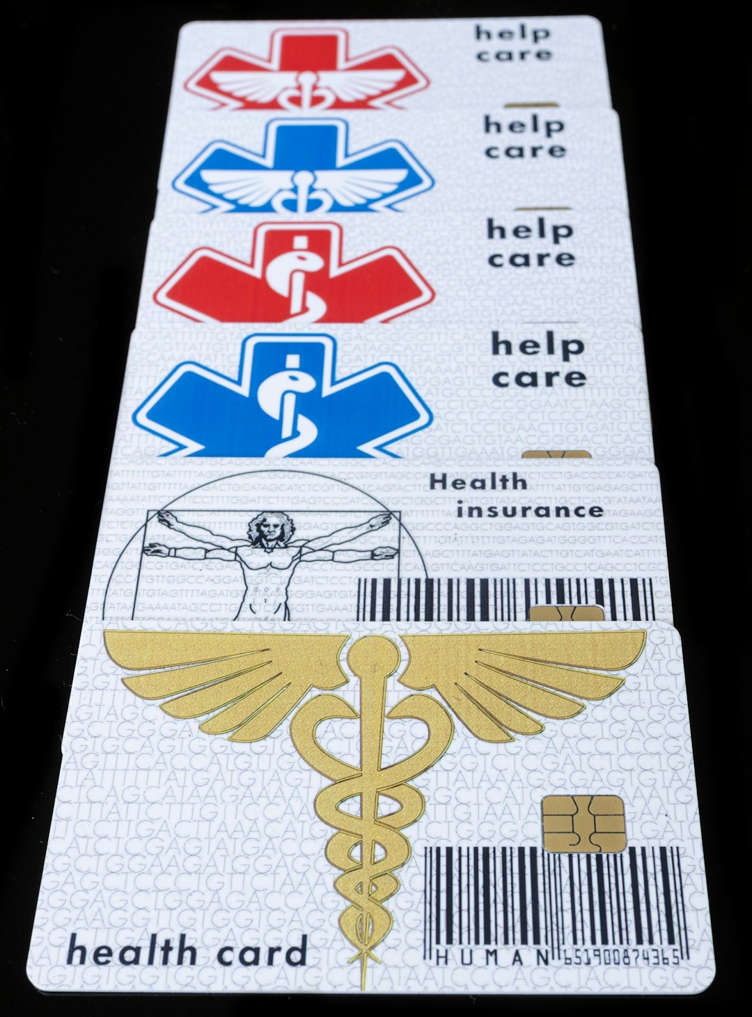 Stack of health insurance cards with medical symbols and DNA patterns.