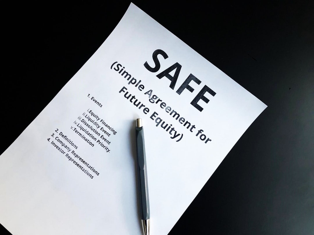 Legal document for SAFE investment with a pen.
